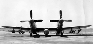 Front view of North American XF-82 fitted with 445-gallon centerline drop tank, ten 5-inch rockets, a 110-gallon drop tank and a chemical tank. Note the six .50 caliber machine guns in the center wing section. (US Air Force)